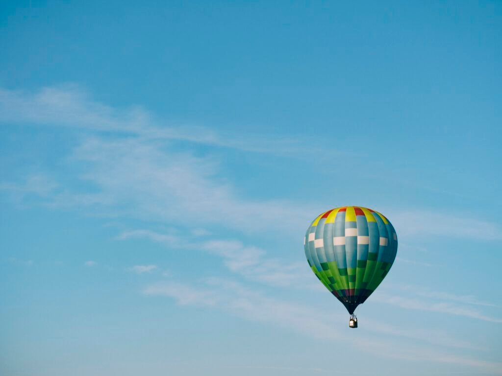 Colourful hot air balloon in flight, a bright and playful image