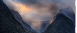 Misty New Zealand mountain valley at sunset, otherworldly light