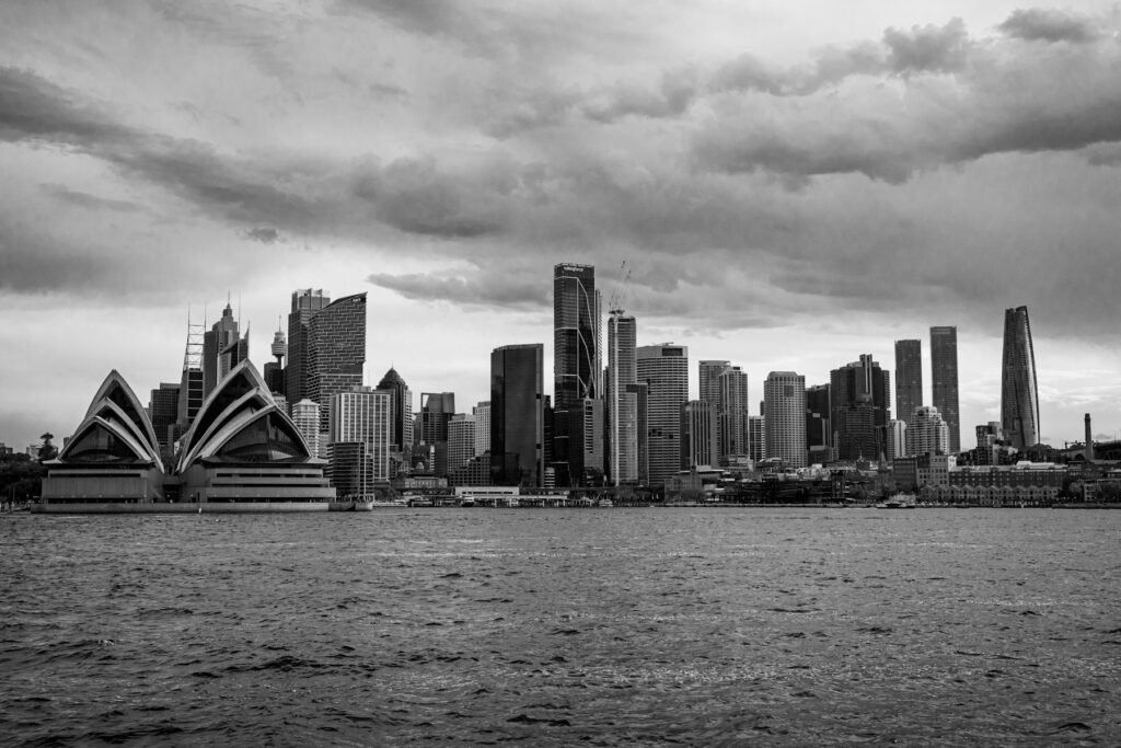Black and white view of the Sydney skyline and Opera House across the harbour