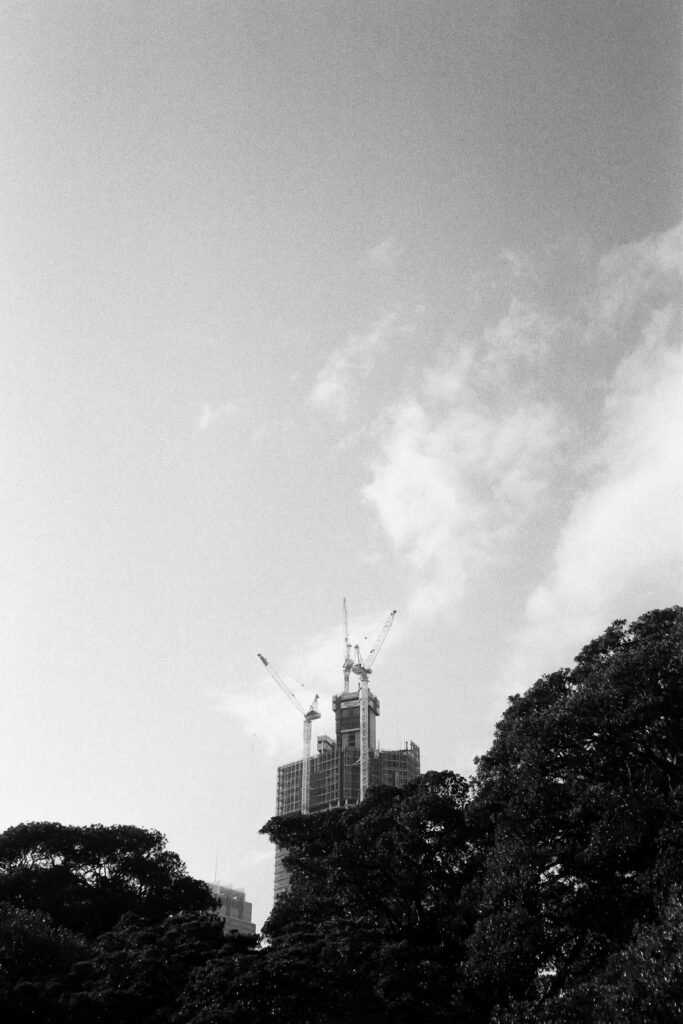 Black and white photograph of an Australian city skyline at dusk
